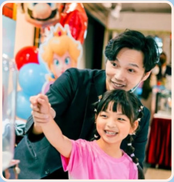 Magic Ka and a child looking toward a party surprise